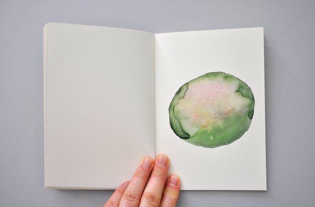 Overview of handmade artists book with atmospheric watercolour drawings. Photography.